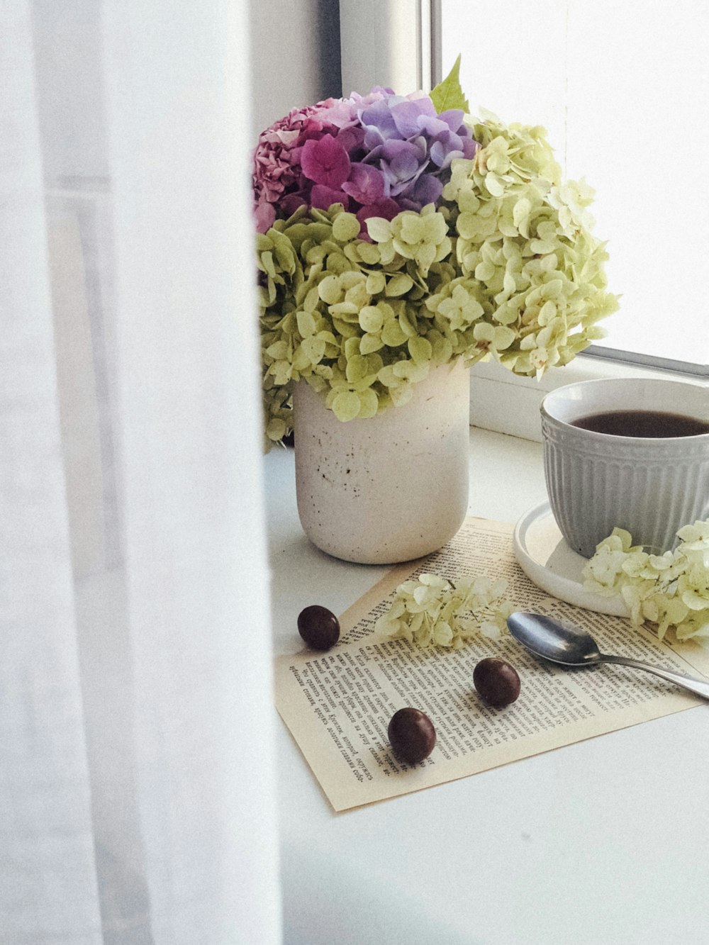 white and purple flower bouquet on white table