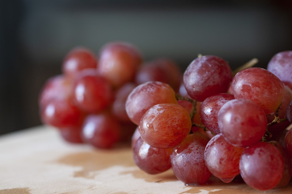 red round fruits on brown wooden table