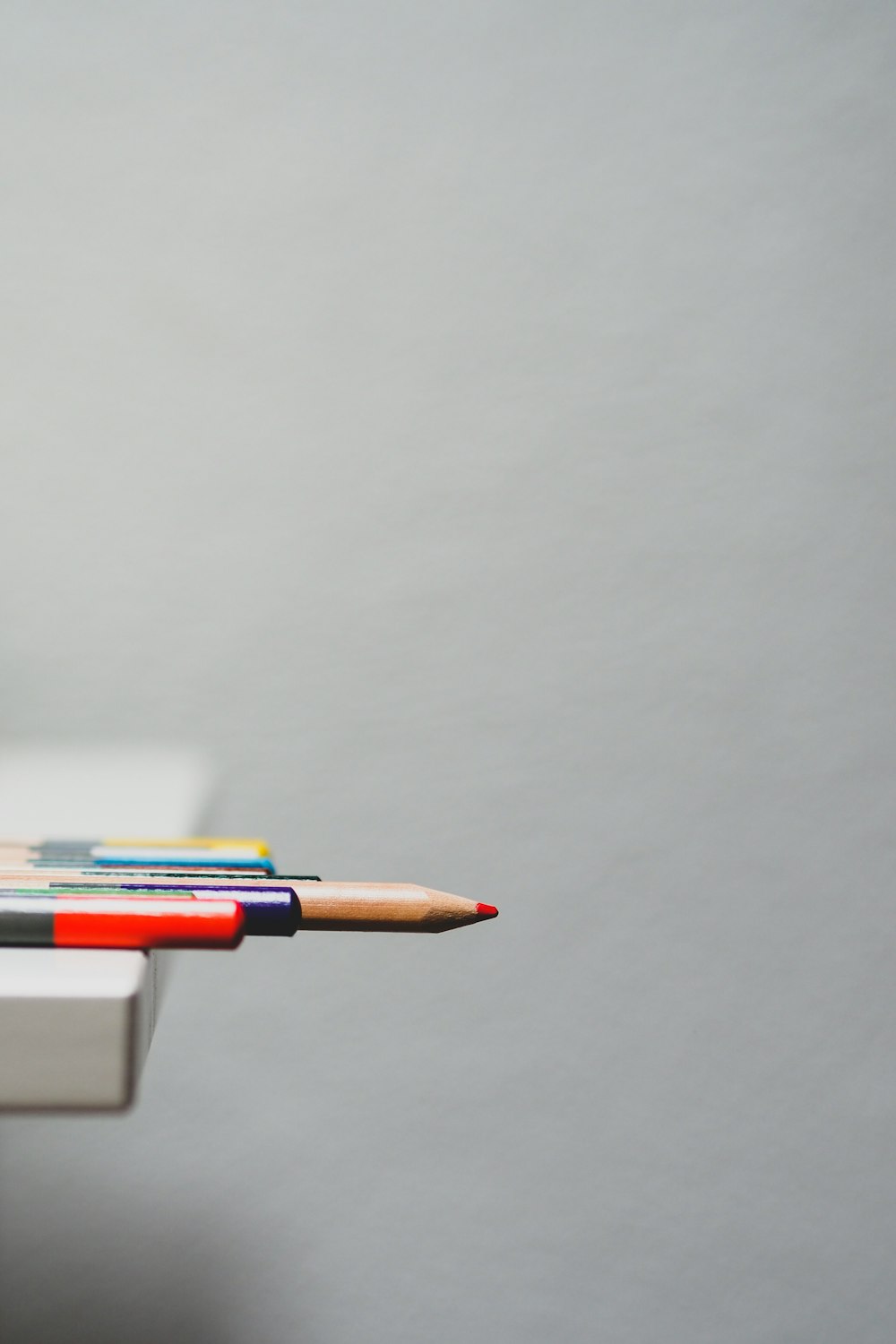 white and red click pen on white table