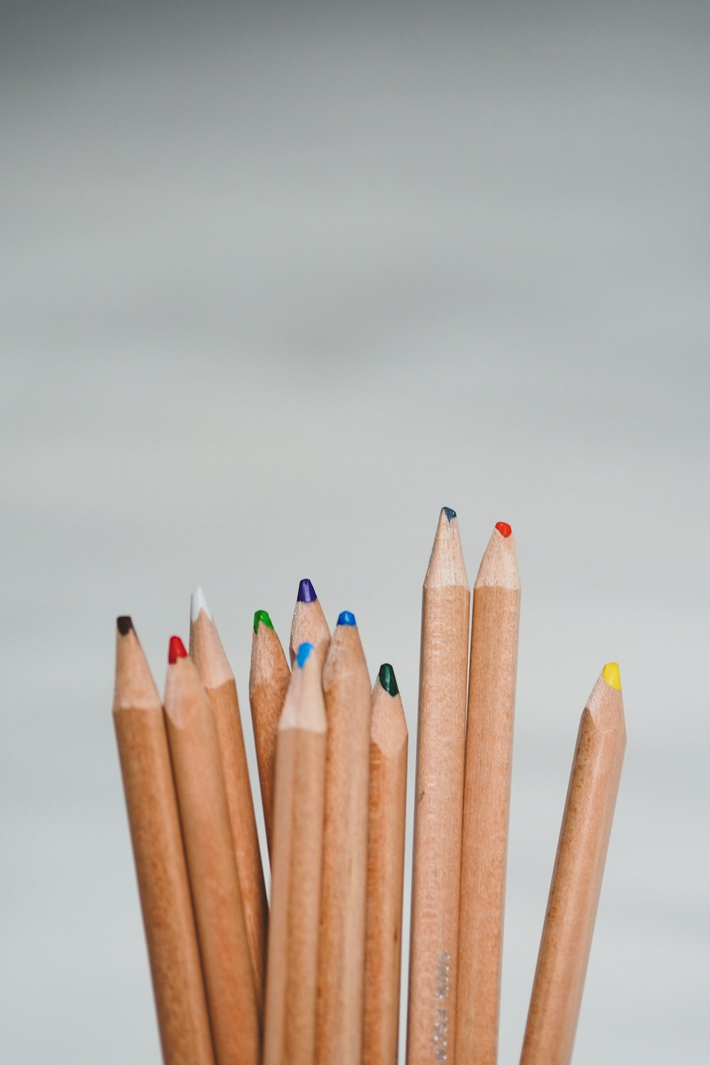 blue and brown pencils on white surface