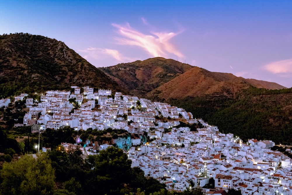 white houses near mountain under blue sky during daytime