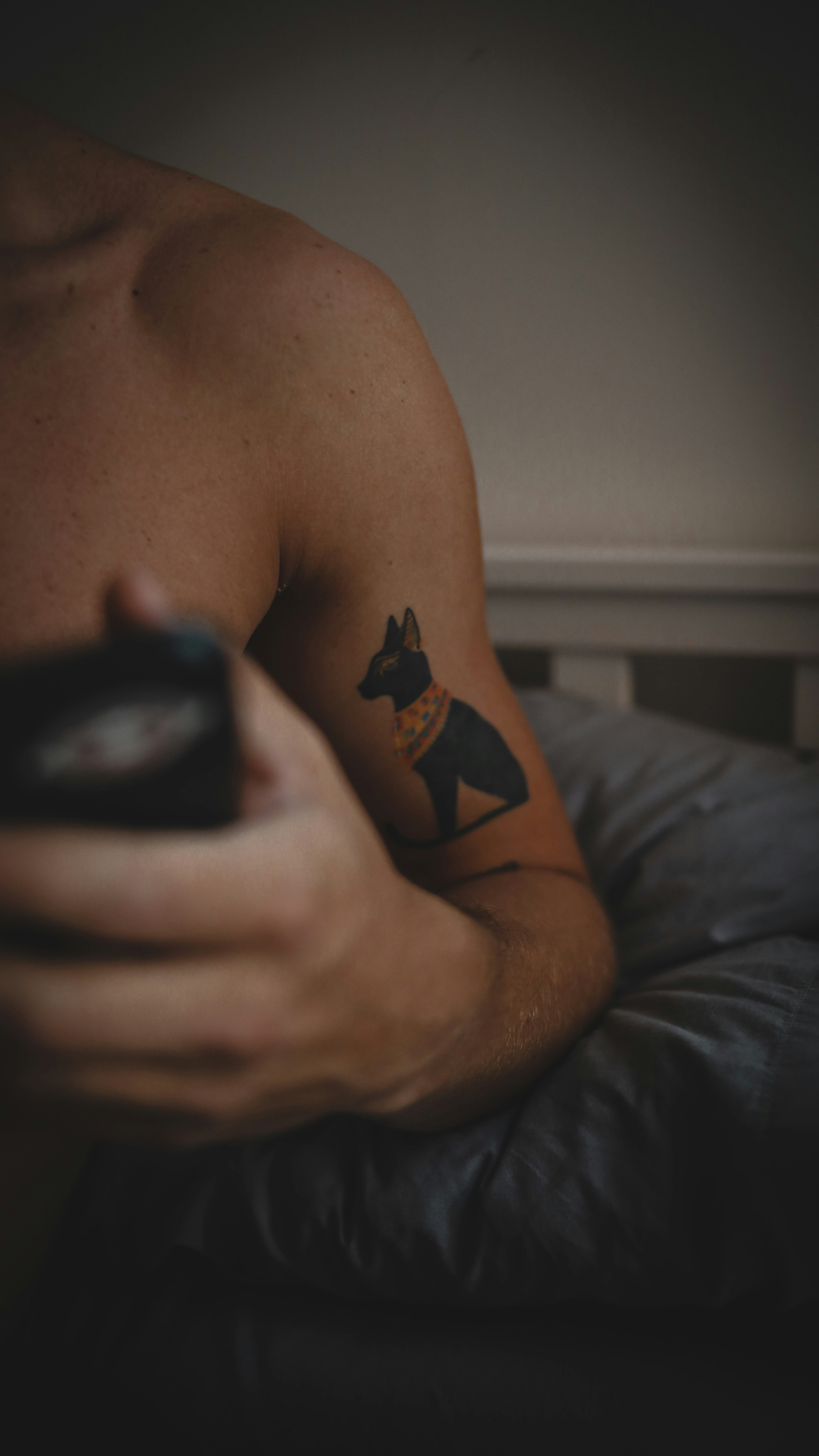 man with black and brown tattoo on his right arm