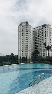 A high-rise building with a rooftop pool.