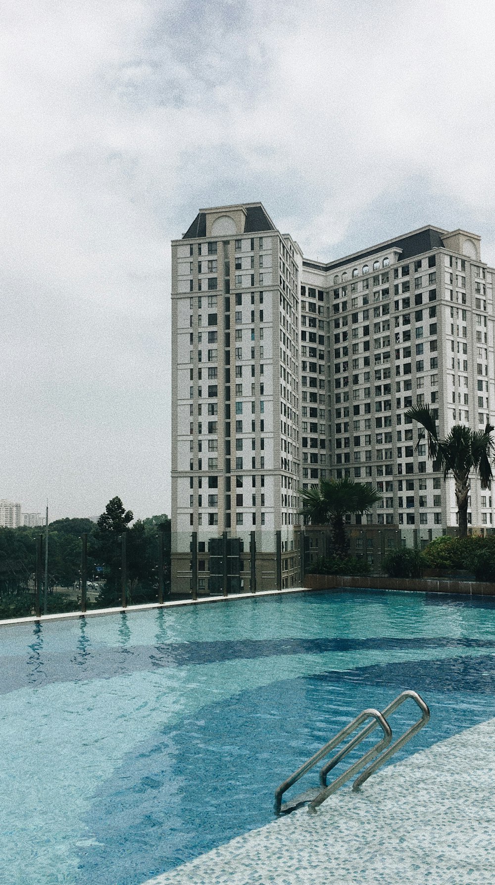 white concrete building near swimming pool during daytime