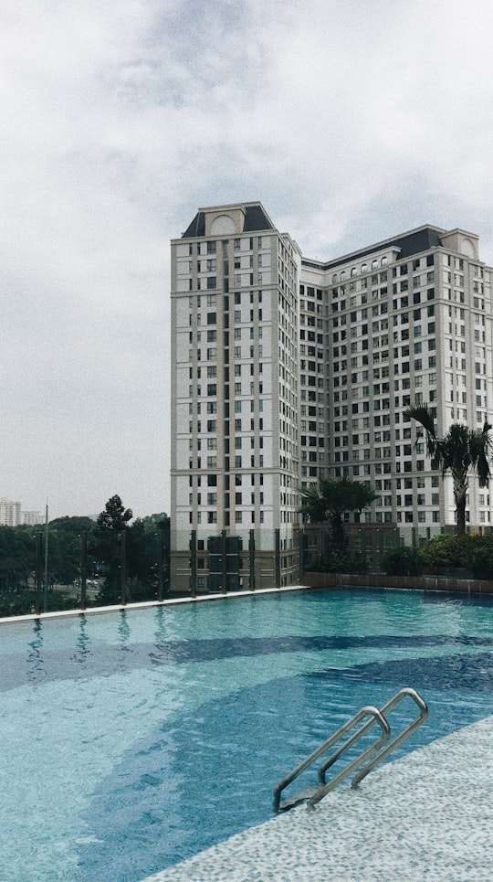 white concrete building near swimming pool during daytime in 130 Đường Hồng Hà Vietnam