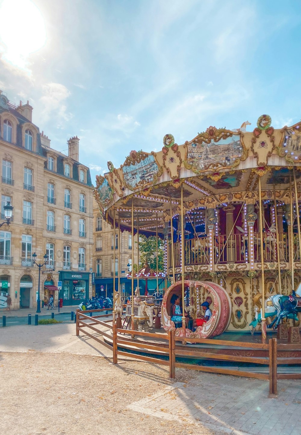 people riding on carousel during daytime