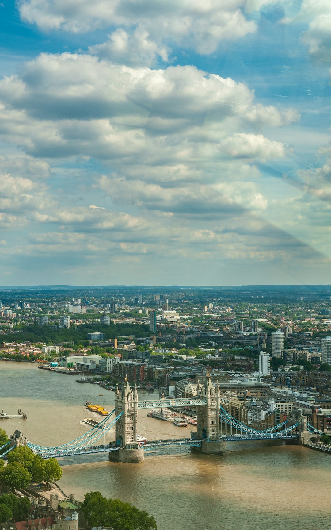 city buildings under white clouds and blue sky during daytime