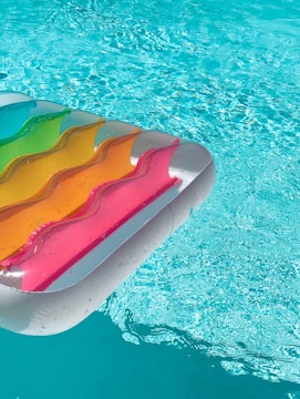 red yellow and green inflatable pool float on swimming pool