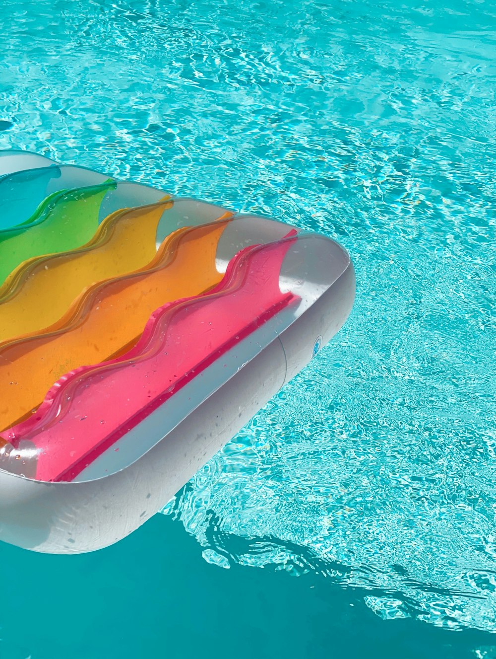 red yellow and green inflatable pool float on swimming pool