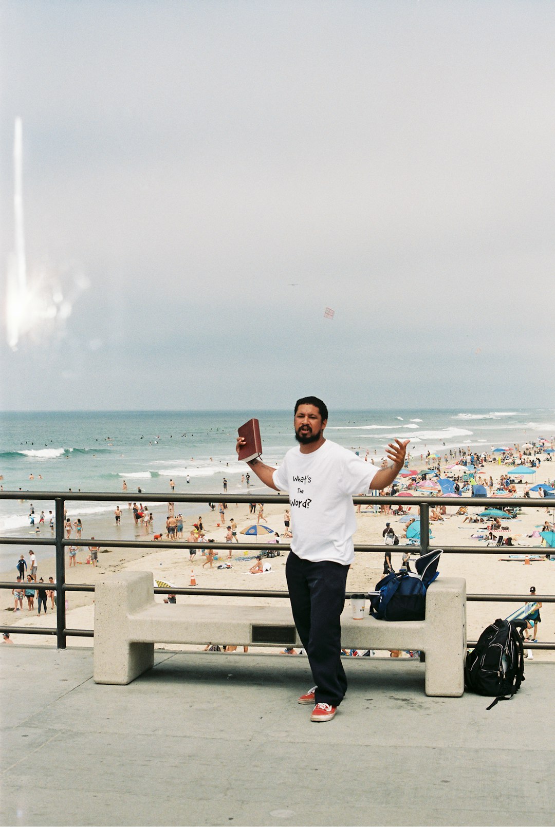 man in white crew neck t-shirt and black pants standing on white wooden fence near near near near near