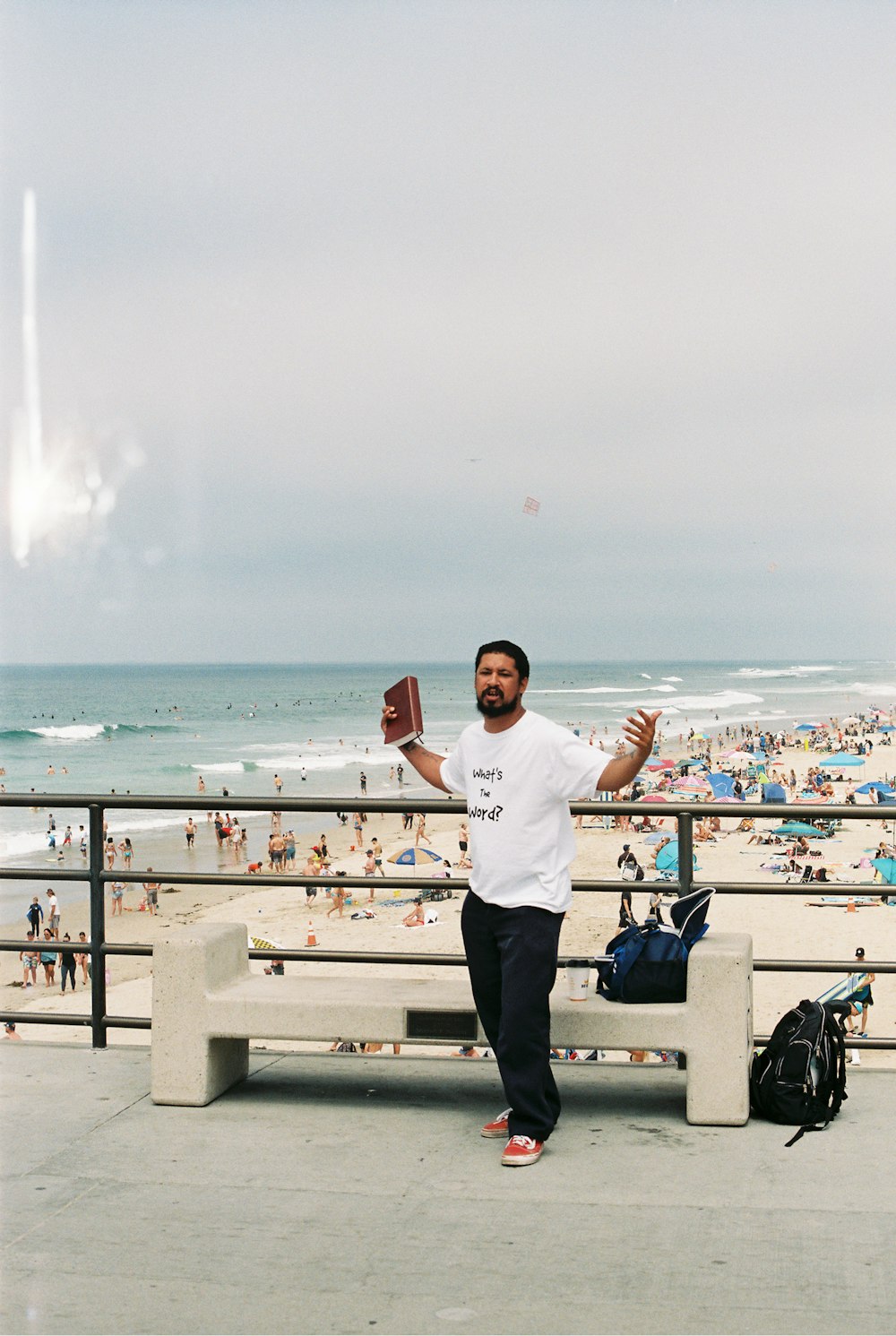 man in white crew neck t-shirt and black pants standing on white wooden fence near near near near near