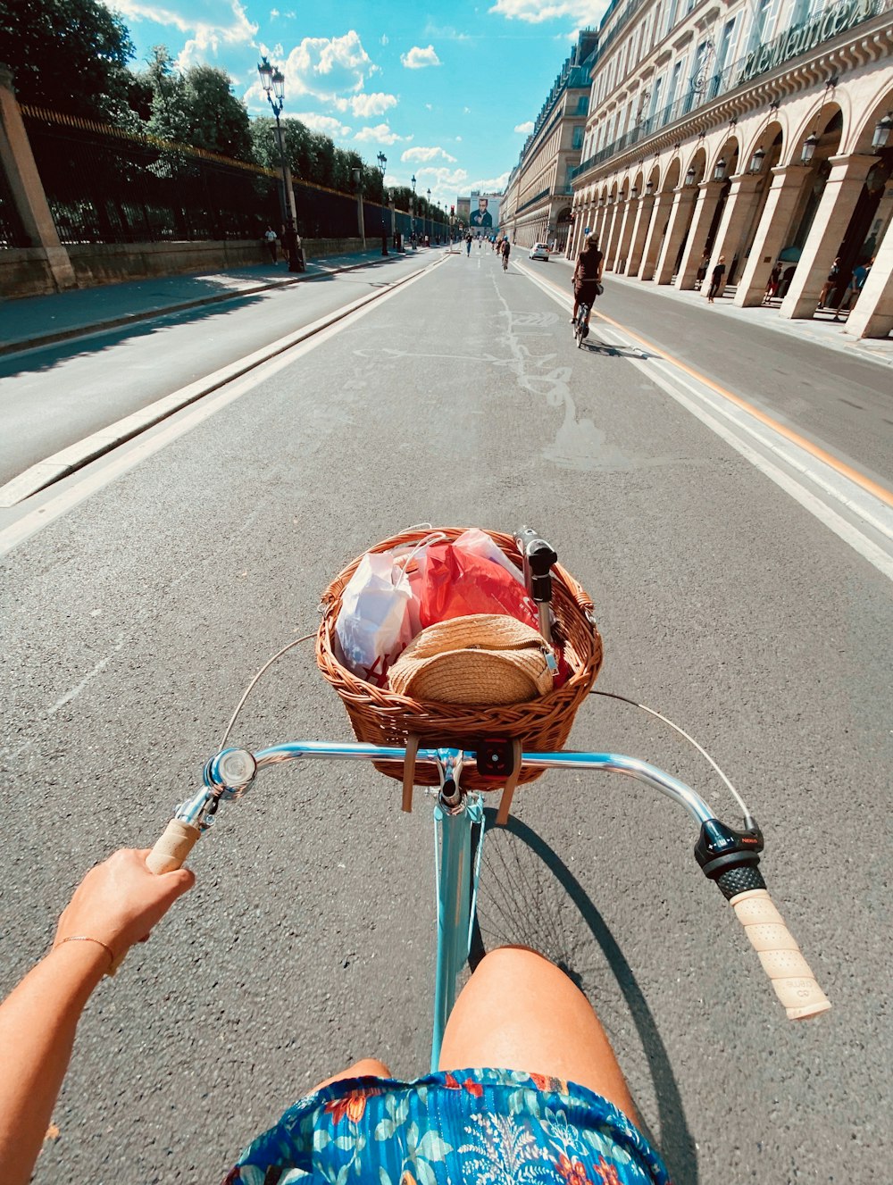 person holding blue bicycle handle bar