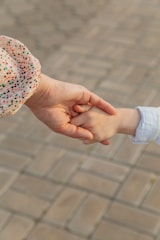 person holding white red and blue floral textile