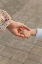 person holding white red and blue floral textile