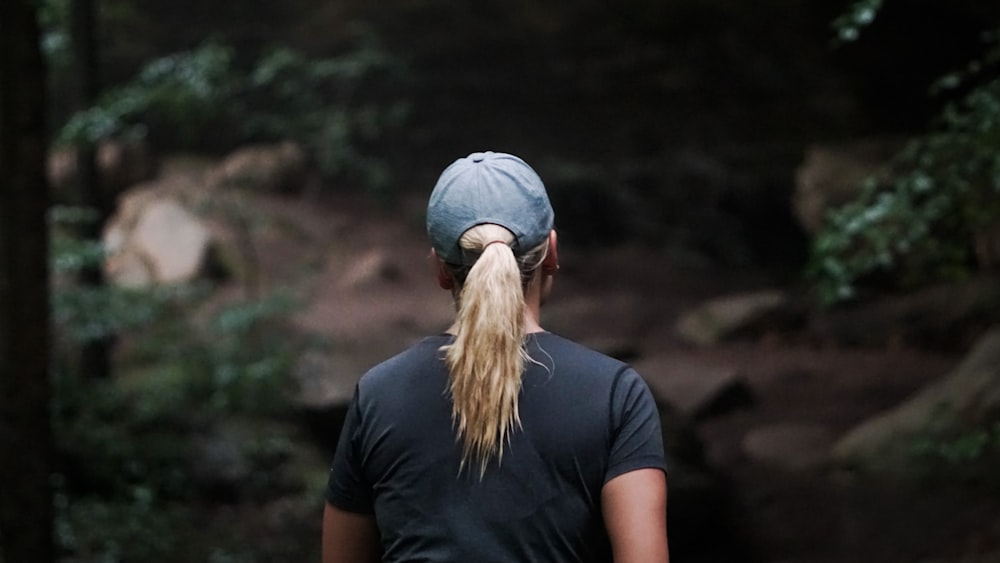 woman in black crew neck t-shirt and blue denim cap