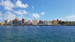 A colorful street in Willemstad with its iconic Dutch colonial buildings under a bright blue sky