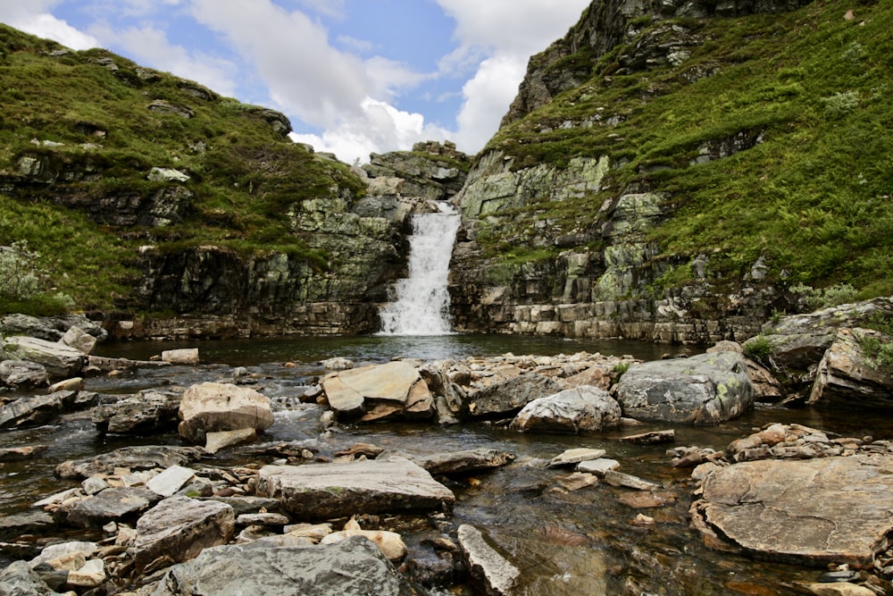 green and gray mountain with water falls