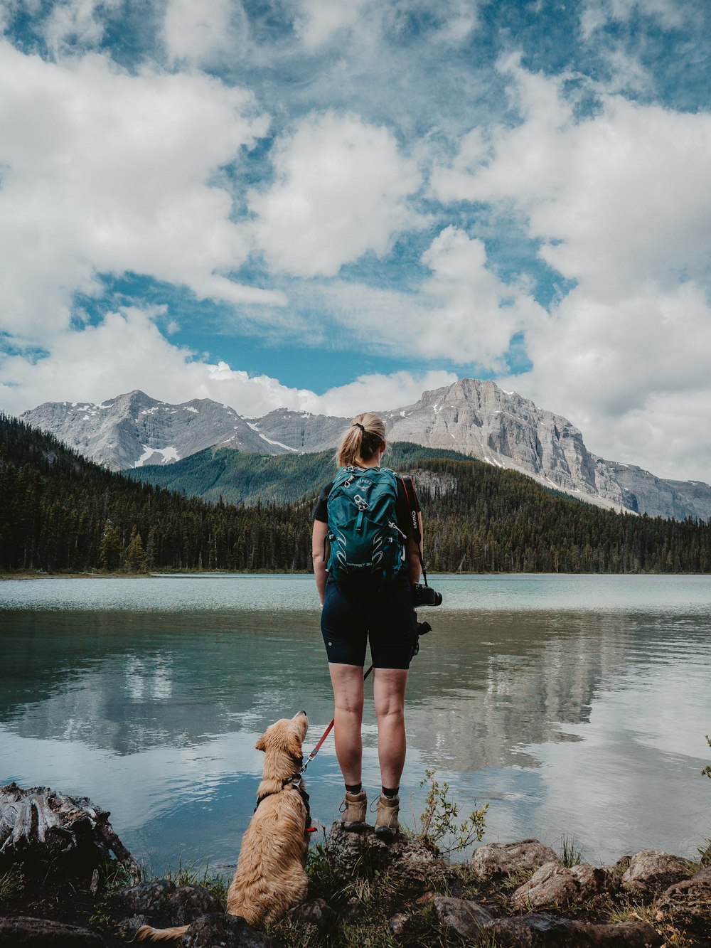 woman in black jacket standing on river during daytime