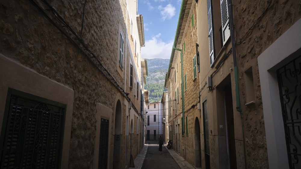 empty hallway between concrete buildings during daytime