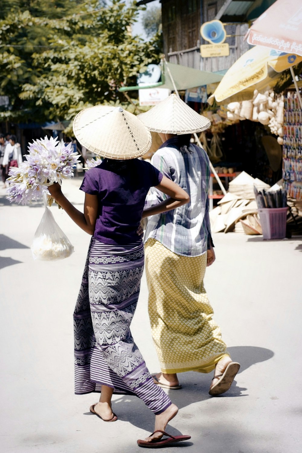 woman in blue and white dress wearing white sun hat