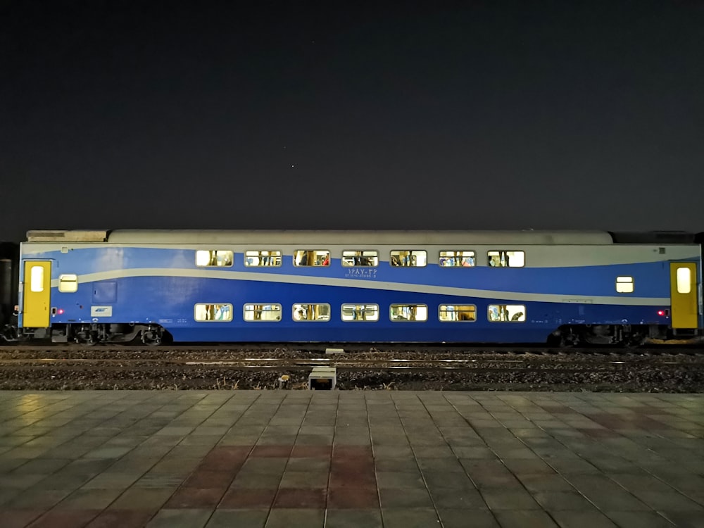 blue and white train on rail