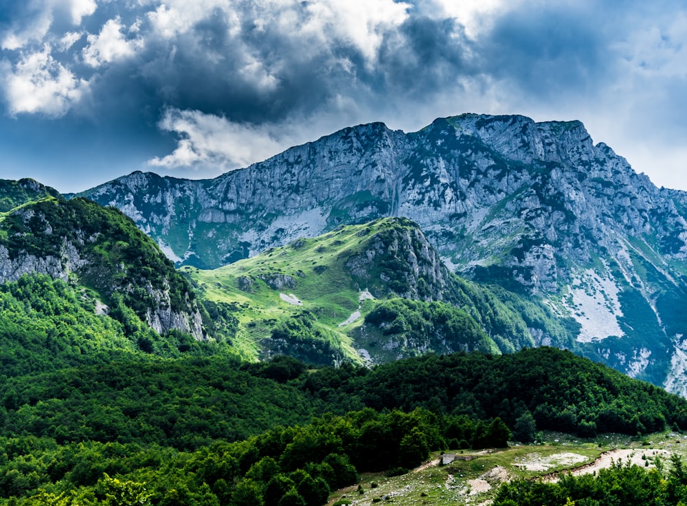 green and gray mountain under cloudy sky during daytime