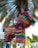 Colorful handcrafted piñata hanging in a festive Mexican party setting.