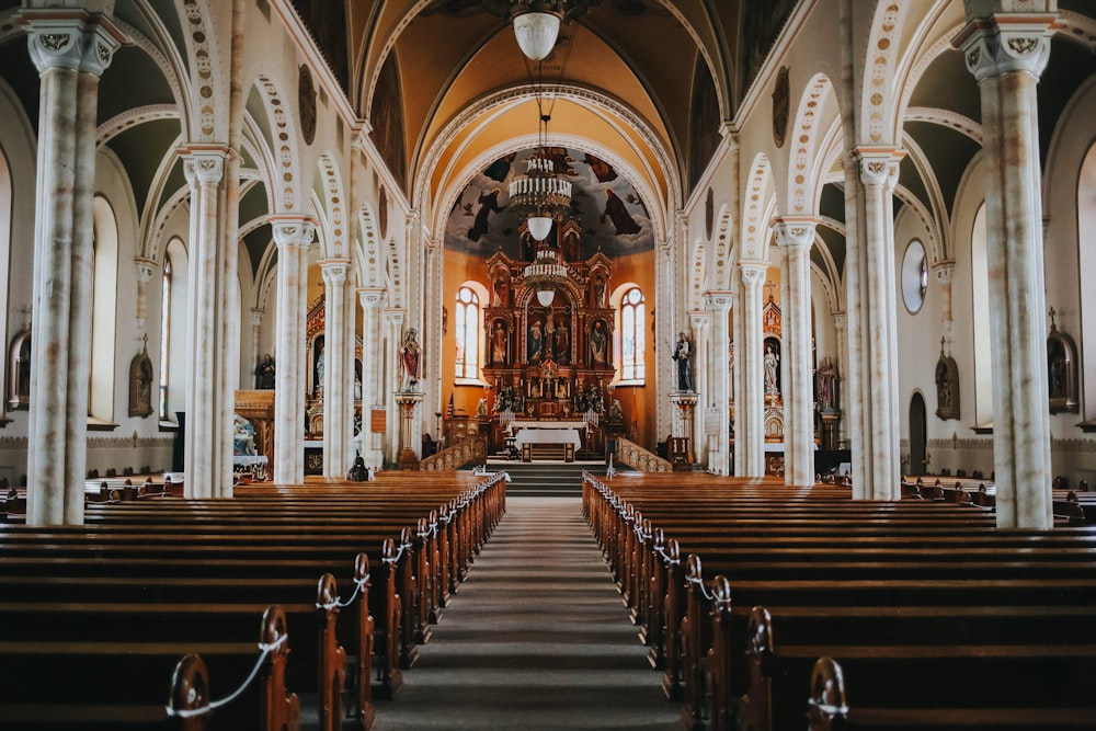 brown wooden chairs inside cathedral