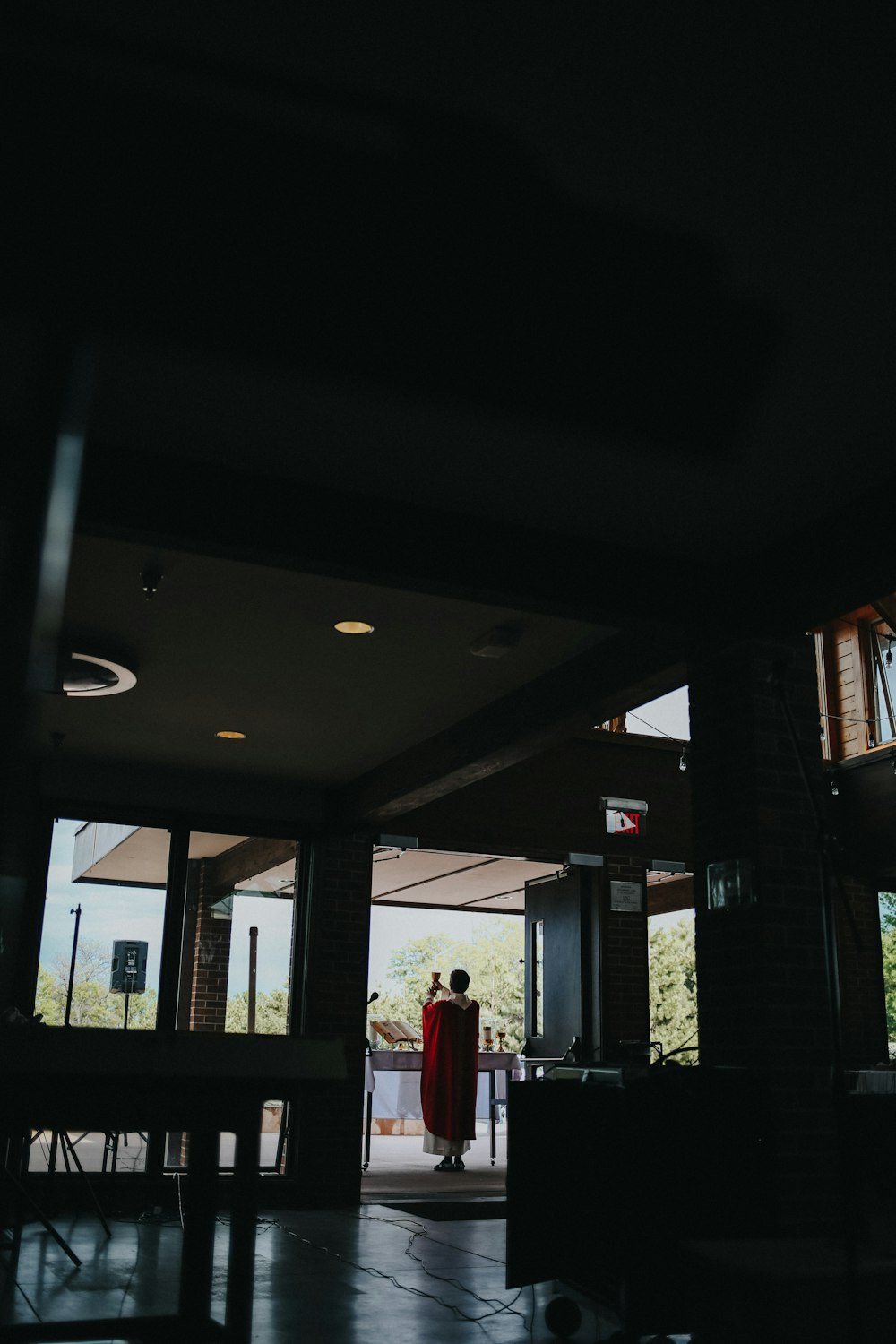 woman in red dress standing near brown wooden door