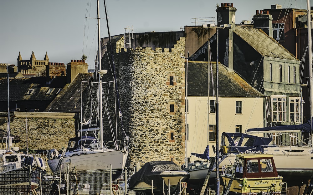 a group of boats sitting in a harbor next to buildings