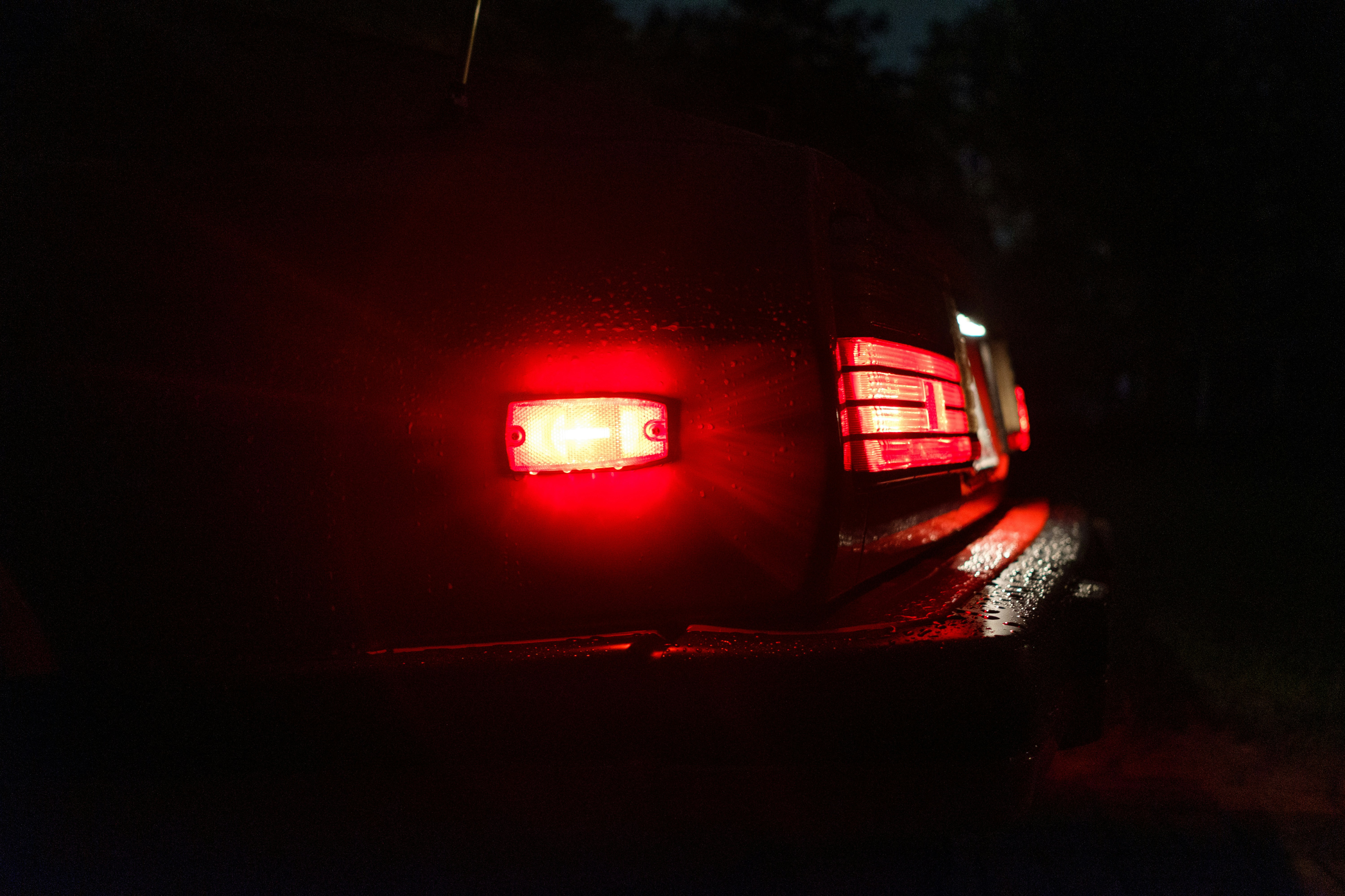 red car on road during night time indiana teams background