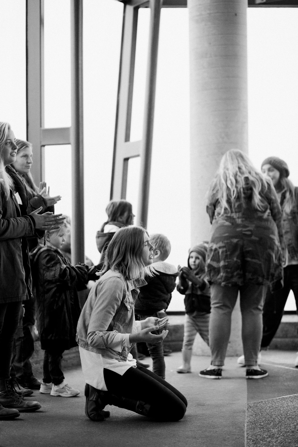 grayscale photo of people walking on hallway