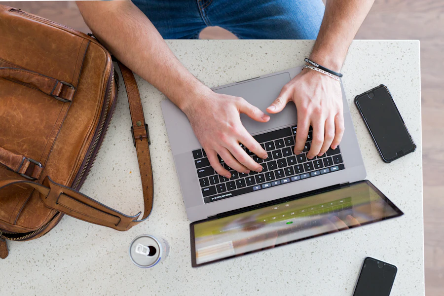 Hands using a laptop in a focused workspace