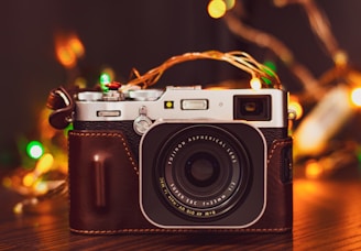 A cozy photo studio corner with seasonal decorations and camera equipment.