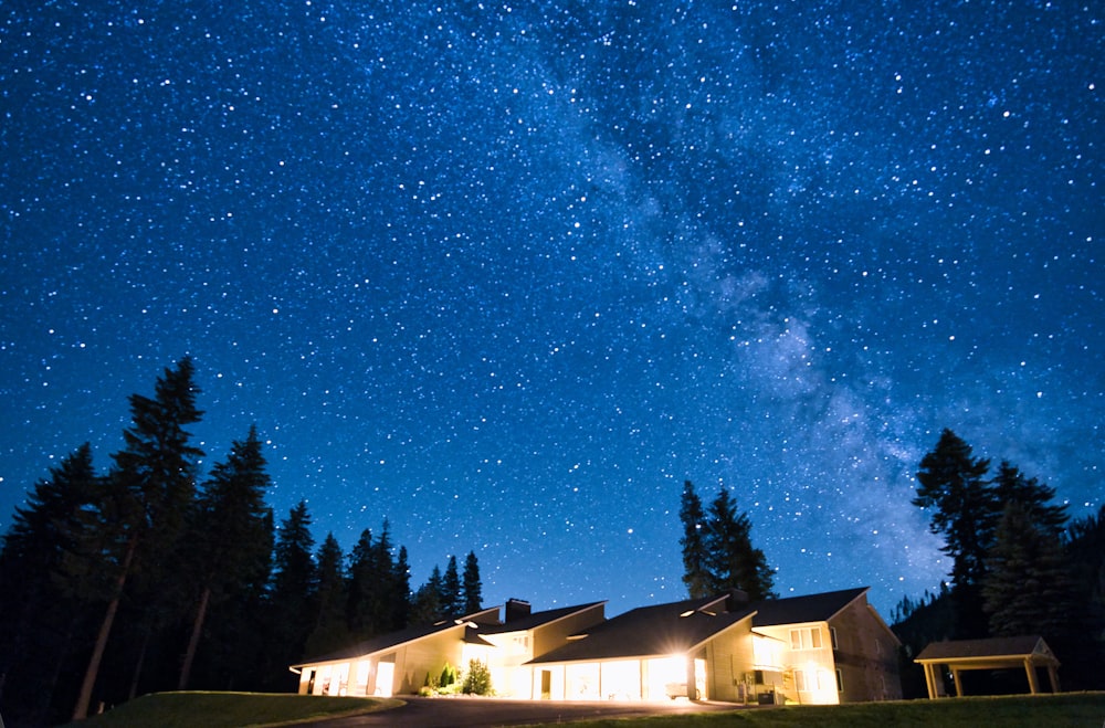 white and brown house under blue sky during night time