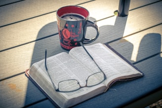 red and white ceramic mug on white paper