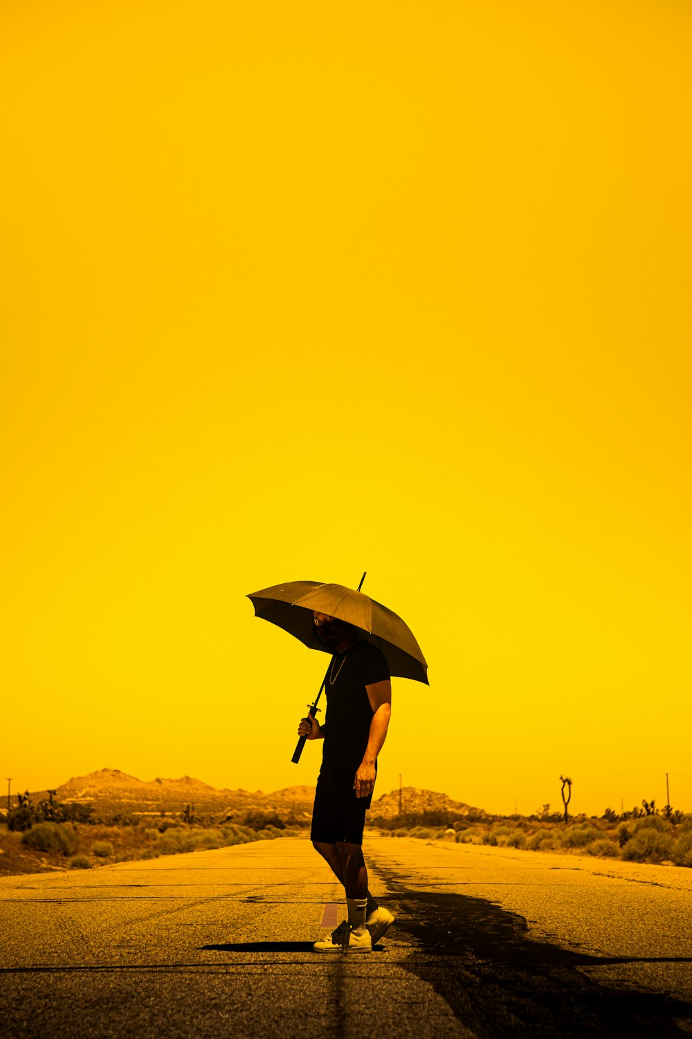 person in black jacket holding umbrella