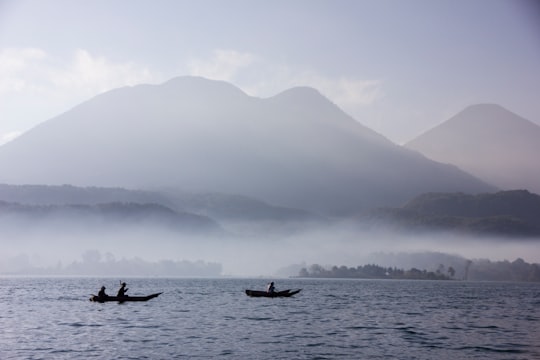 person riding on boat on sea during daytime in Lake Atitlán Guatemala