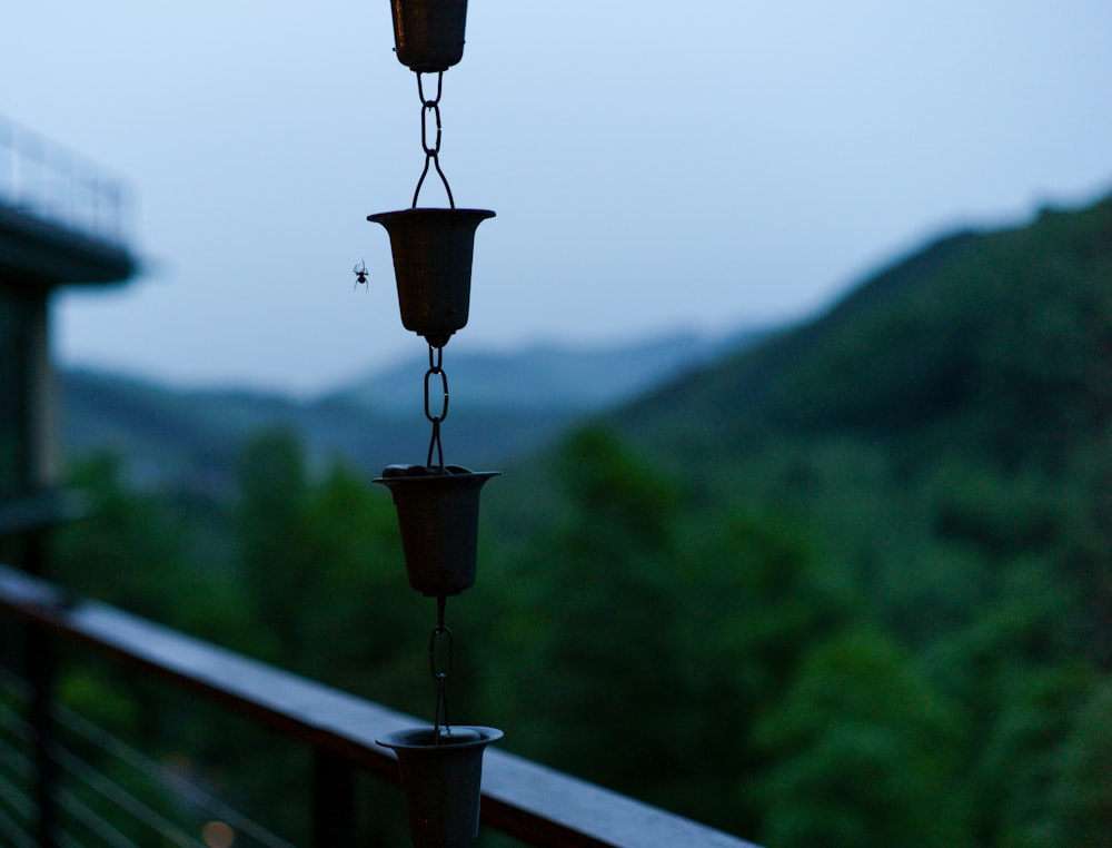 brown hanging pot on brown wooden fence during daytime