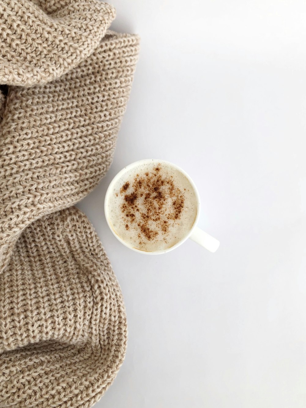 white ceramic mug on white table