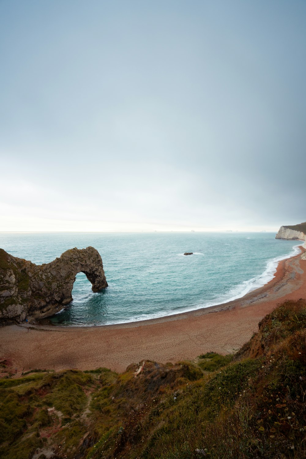 brown rock formation on sea shore during daytime