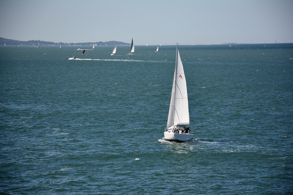 white sailboat on sea during daytime