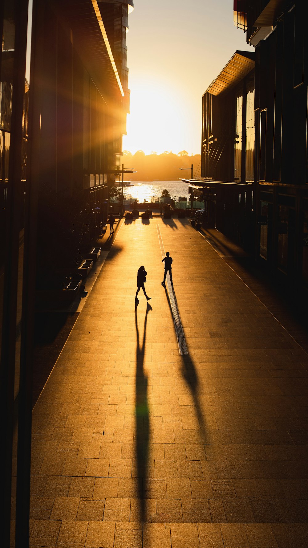 a couple of people that are walking down a sidewalk