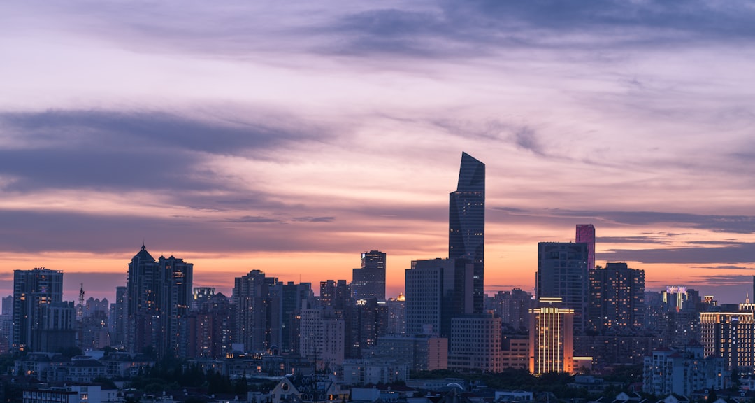 city skyline under cloudy sky during daytime