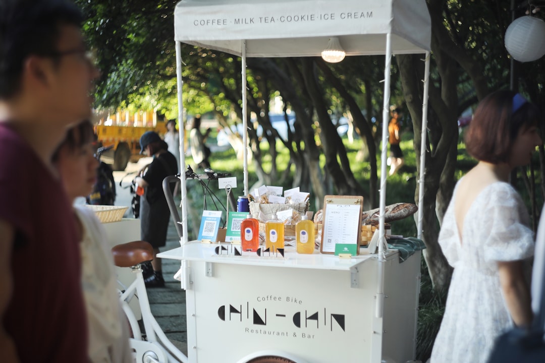 people standing near white and blue table during daytime