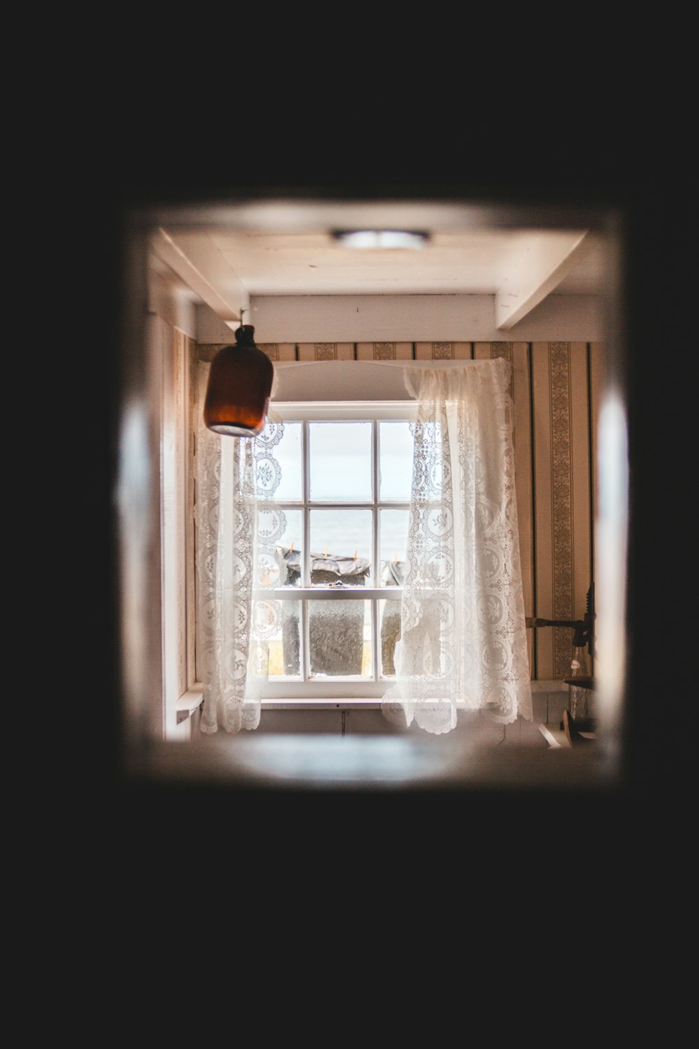 white floral window curtain during daytime