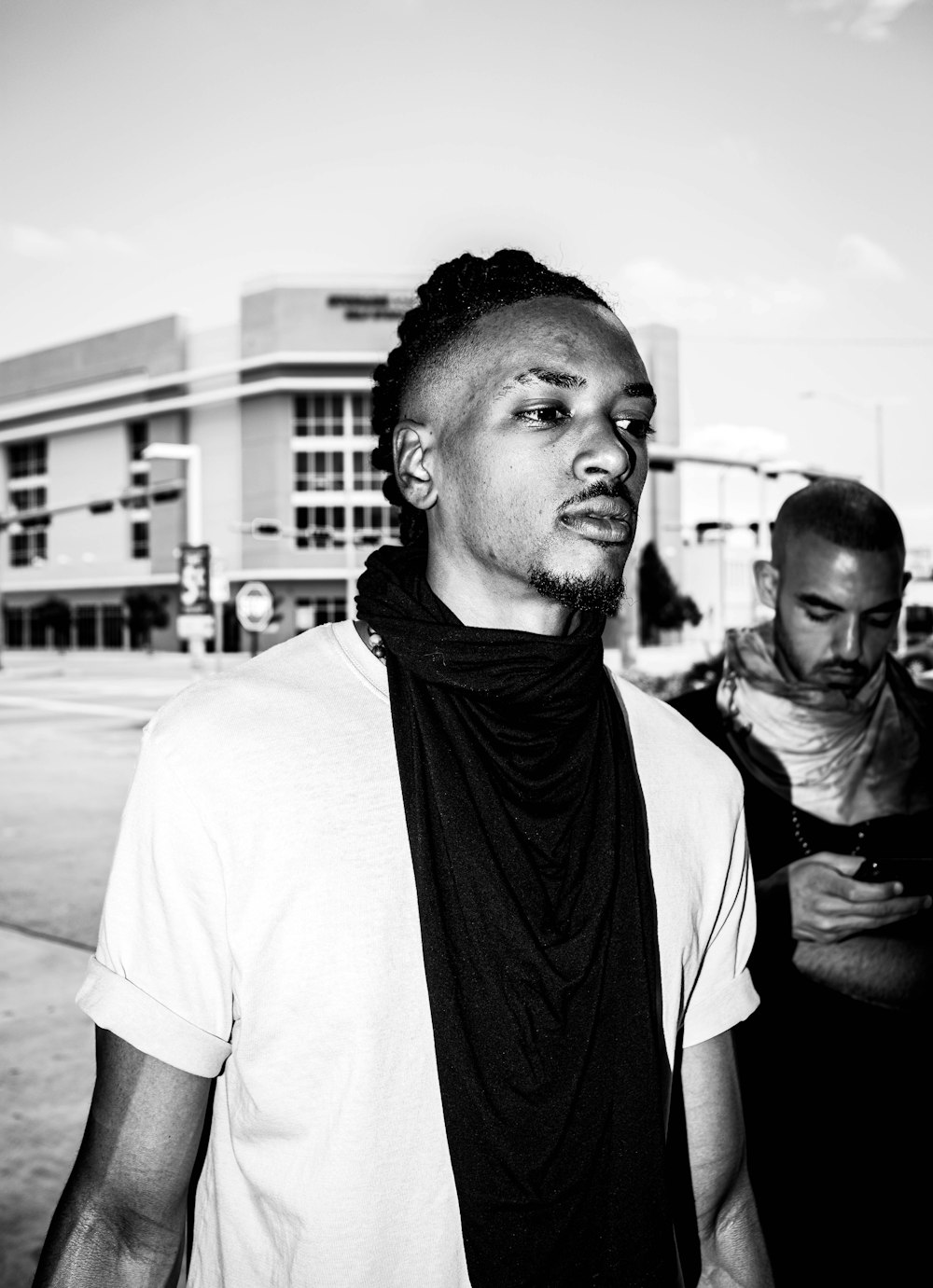 man in white t-shirt and black scarf