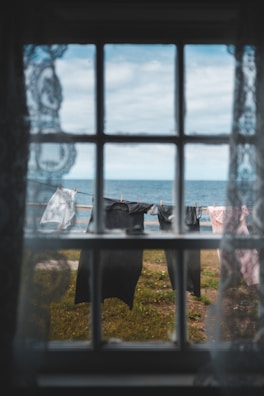 A scenic view of laundry hanging outdoors with clothespins attached.