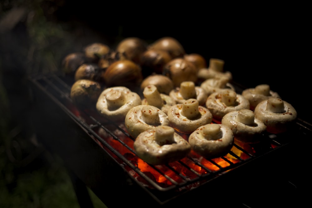 brown and white donuts on black tray