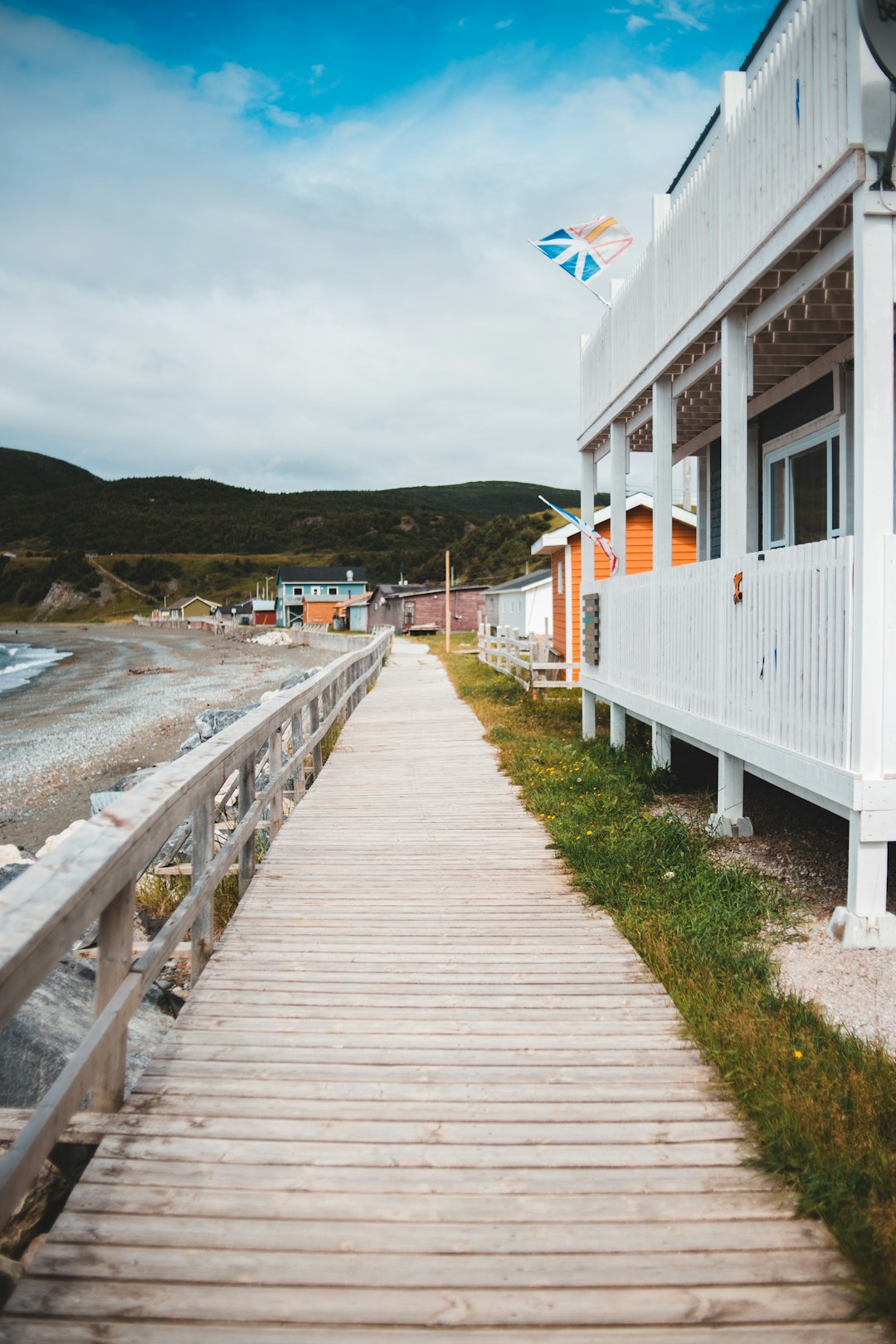 white wooden house near body of water during daytime